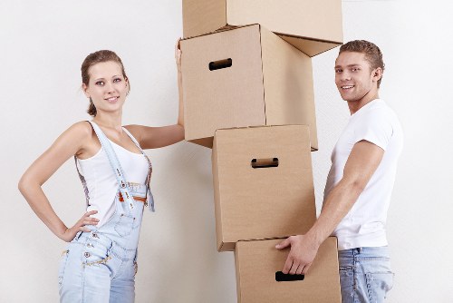 Professional movers packing household items for transport